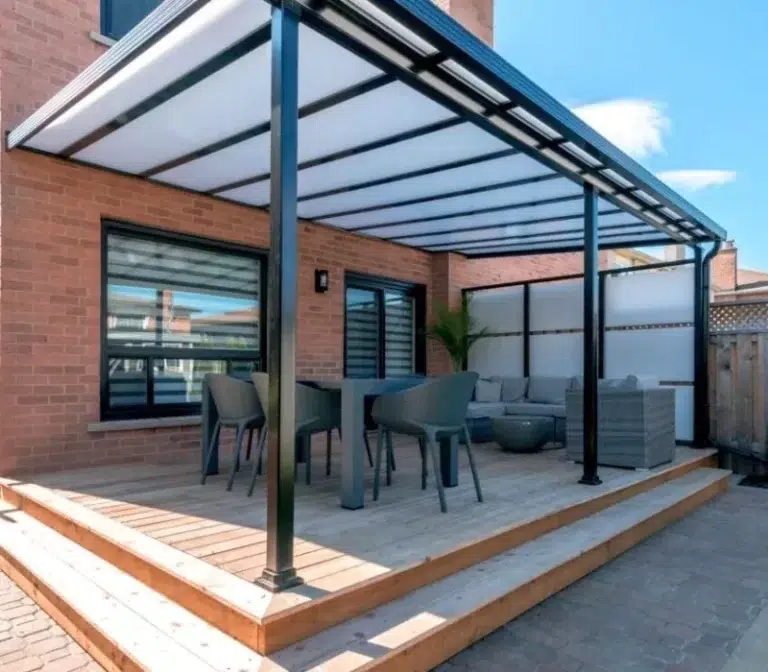 Patio cover with modern design, featuring a seating area and table, enhancing outdoor living space for Sunspace By Sunrise Sunrooms.