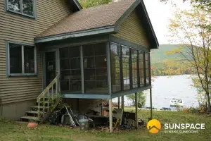 Sunspace sunroom with WeatherMaster Windows overlooking a lake, enhancing outdoor living in Maine.