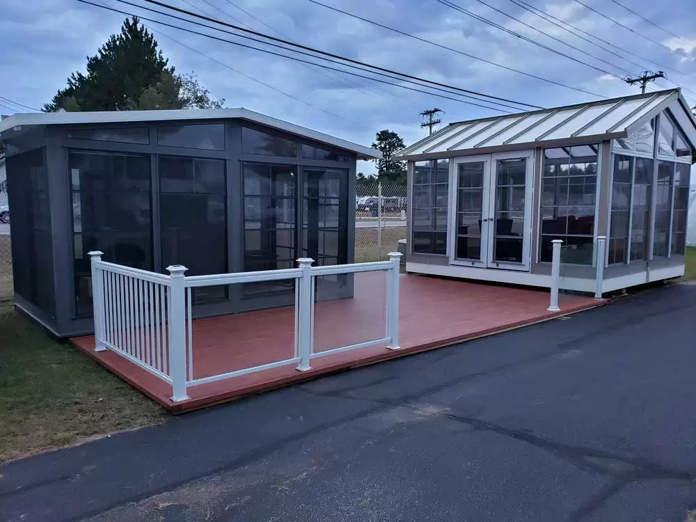 Stylish sunrooms with aluminum railings and durable decking, showcasing outdoor living solutions by Sunspace by Sunrise Sunrooms.