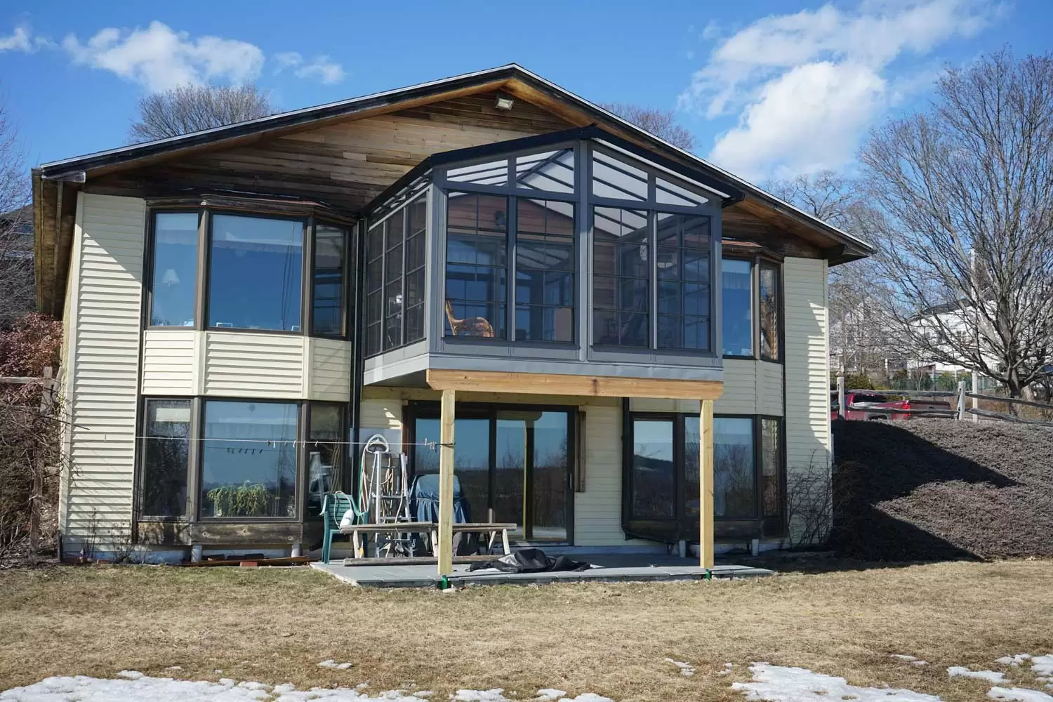 Sunspace sunroom addition featuring large glass windows and a wooden structure, enhancing outdoor living space in Scarborough, ME.