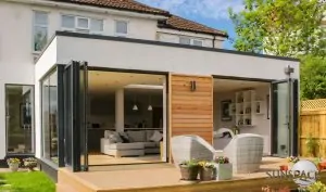 Sunspace WeatherMaster Plus horizontal stacking doors opening to a modern sunroom with outdoor seating, enhancing indoor-outdoor living for Maine homeowners.